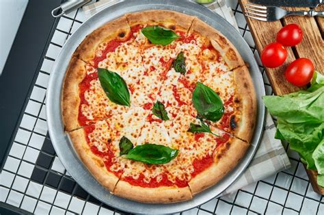 Premium Photo | Classic margarita pizza with mozzarella, tomatoes and basil. italian pizza in a ...