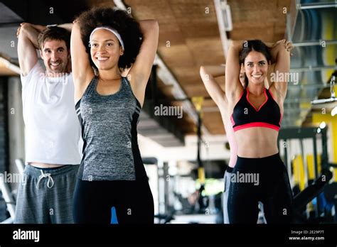 Group of happy multiracial friends exercising together in gym Stock ...