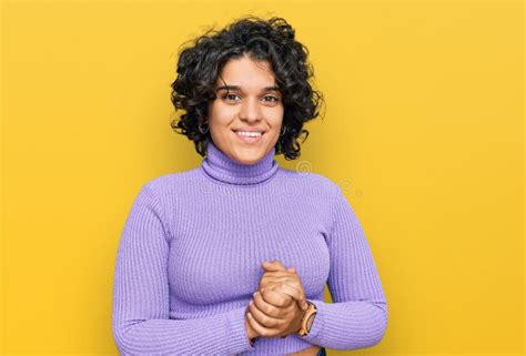 Young Hispanic Woman With Curly Hair Wearing Casual Clothes With Hands