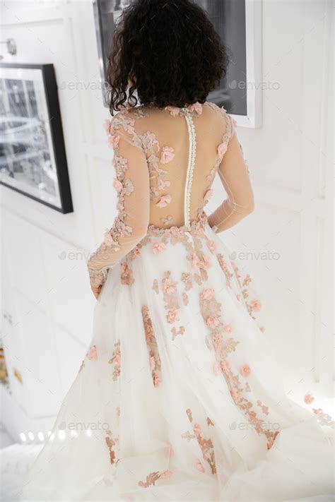 Back View Of Brunette Middle Eastern Woman With Wavy Hair Walking In