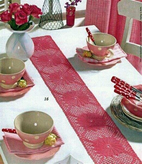 A Pink Table Runner With Polka Dots On It And Plates Cups And Saucers