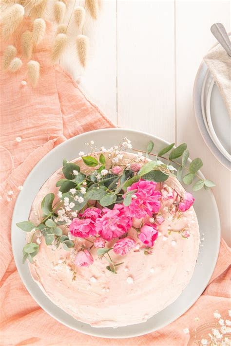 Chocolate Naked Cake With Fresh Roses And Swiss Buttercream On A White Background Stock Photo