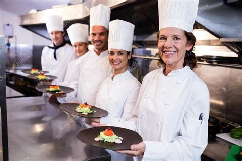 Happy Chefs Presenting Their Food Plates Stock Photo By Wavebreakmedia