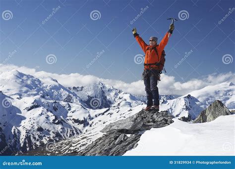 Mountain Climber With Arms Raised On Snowy Peak Stock Photo Image Of