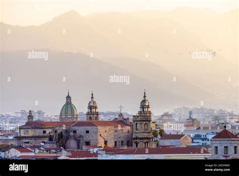 Residential Homes And Historic Church Buildings With Mountains In