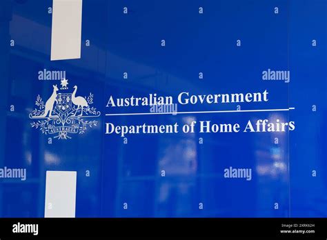 Australian Government Department Of Home Affairs Logo On A Blue Wall