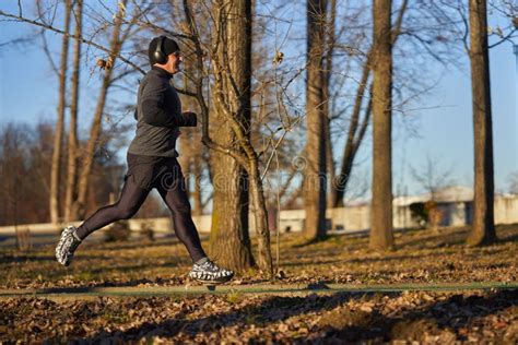 Mature Man Running In The Park With Headphones Stock Image Image Of