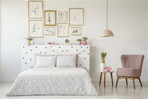 Dotted, Double Bed, Paintings with Gold Frames and Pink Armchair Stock ...
