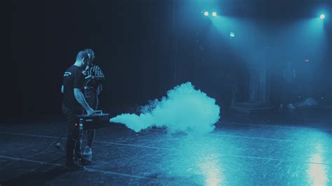A stage worker fills the smoke scenes from the smoke machine