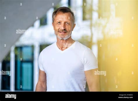 Confident Mature Man Wearing White T Shirt Stock Photo Alamy