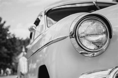 Retro Styled Front Of A Classic Car With Round Headlights In Black And