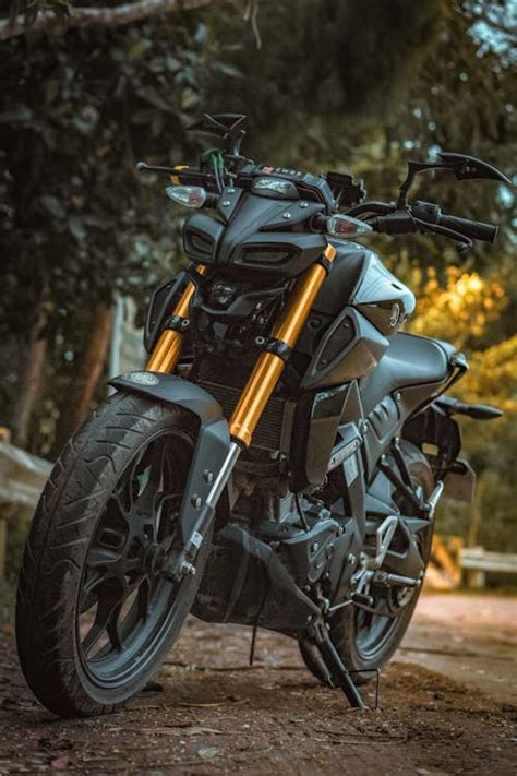 Black And Yellow Motorcycle Parked On The Side Of The Road · Free Stock