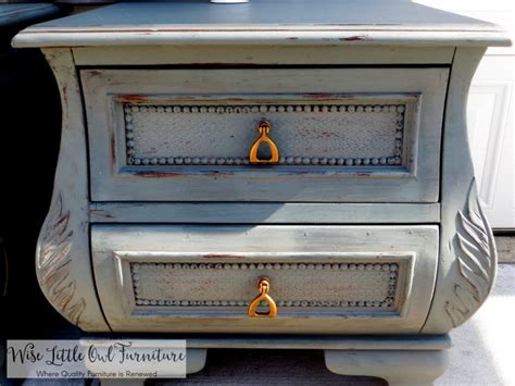 An Old Dresser Is Painted White With Gold Handles