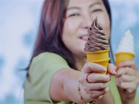 Premium Photo Midsection Of Woman Holding Ice Cream