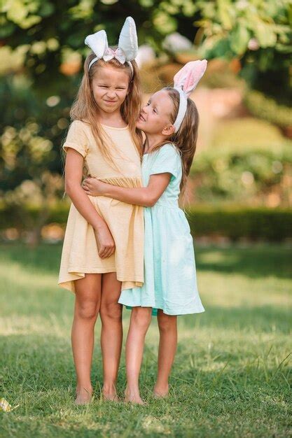 Premium Photo Sisters Embracing While Standing Outdoors