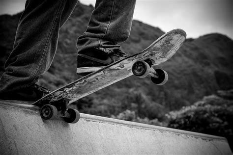 Person Standing On Skateboard Grayscale Photography · Free Stock Photo