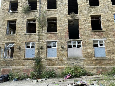 Deserted Victorian Mill With Plants And Rubbish In Bradford