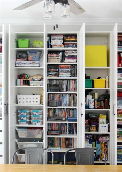 A Room Filled With Lots Of Books And Other Items On Shelves Next To A Table