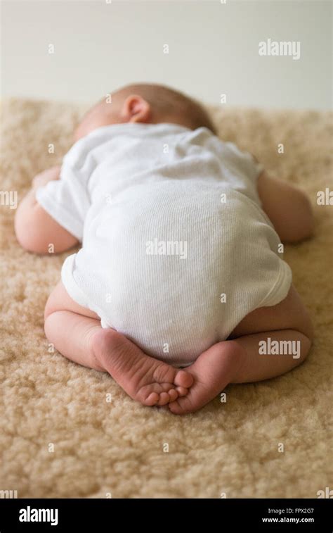 Newborn Baby Sleeping On Tummy On Sheepskin Rug Stock Photo Alamy