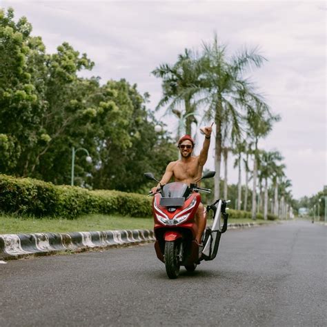 Surfer,Rides,On,Motorbike,With,Surfboard.,Bali,Island,,Indonesia - Travel Off Path