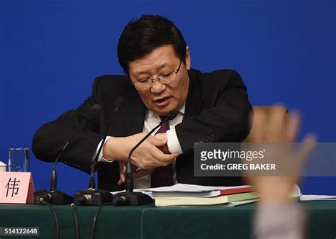 Chinese Finance Minister Lou Jiwei Checks His Watch During A National News Photo Getty Images