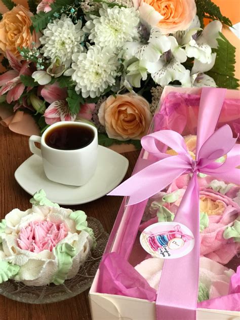 A Cup Of Coffee And Some Flowers On A Table