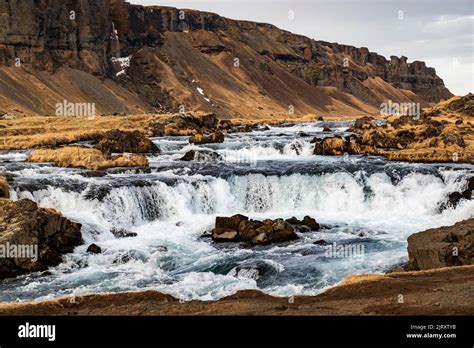 Cascade of the picturesque Fossálar waterfall situated just by the