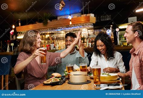 Young Multiracial Group Of Friends In Casual Clothing Celebrating With