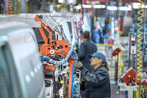 Female Worker On Vehicle Production Line In Car Factory Stock Photo