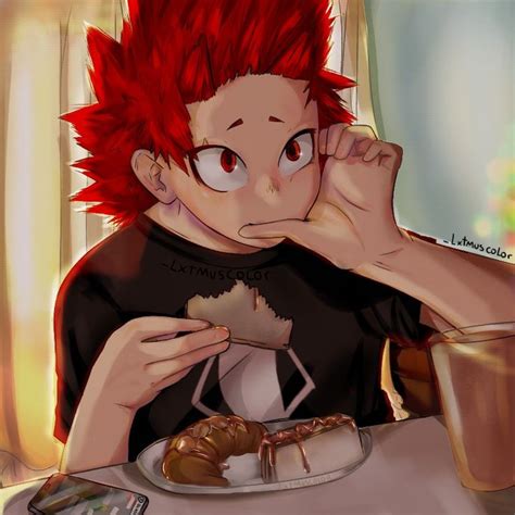 A Boy With Red Hair Sitting At A Table Eating Food