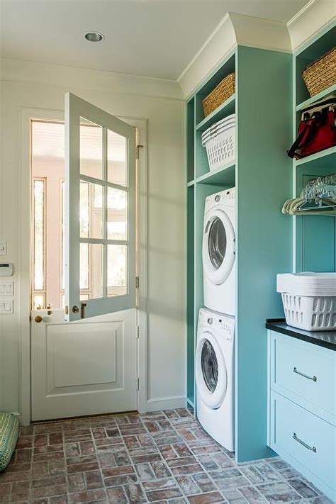 Farmstyle Cottage Laundry Room Displays Blue Cabinets With Red Brick