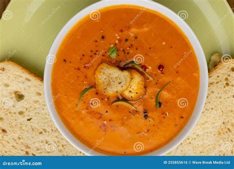 Horizontal Image Of Bowl Of Tomato Soup With Garnish And Sliced White