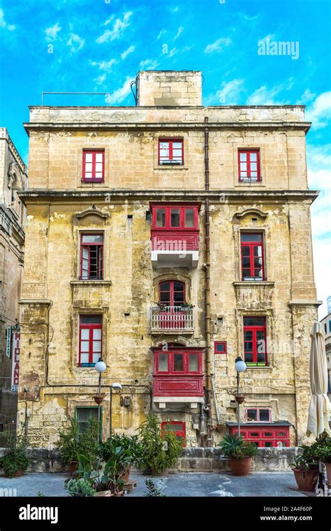 Typical Maltese Residential Building With Brightly Coloured Timber Front Doors Louvered Windows