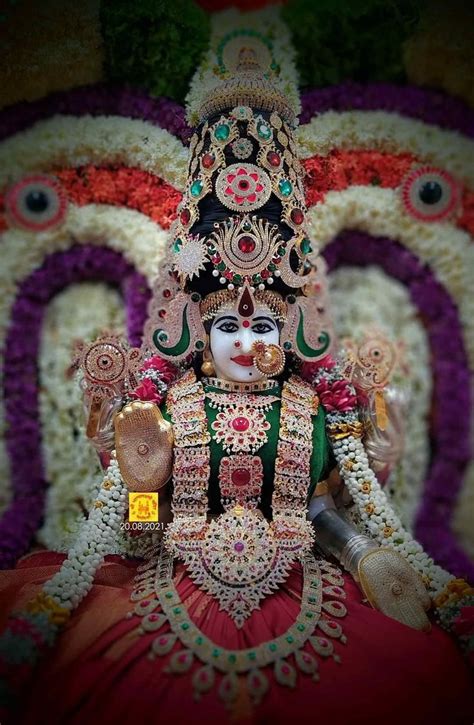 An Idol Is Displayed In Front Of A Colorful Wall With Flowers And