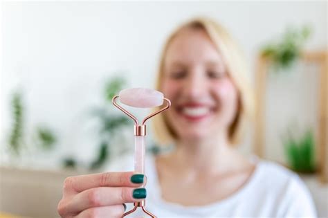 Premium Photo Woman Doing Self Massage With Rose Quartz Face Roller