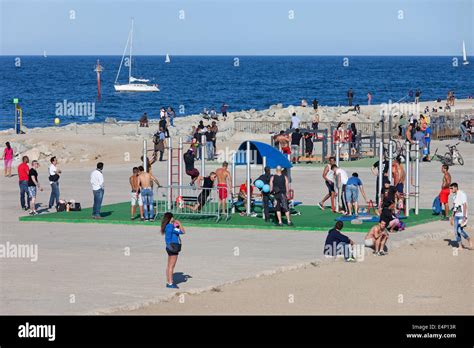 People Working Out On Barceloneta Promenade Outdoor Gym With Exercise