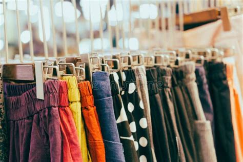 Close Up Of Colorful Pants Hanging On Hanger In Shop Stock Photo