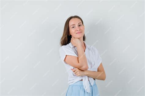 Free Photo Young Woman Holding Hand On Neck And Smiling In White