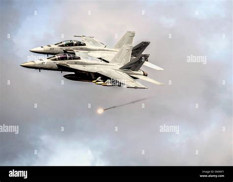 Two Us Navy F A 18f Super Hornet Fighter Aircraft Fire Flares As They Pass The Aircraft Carrier