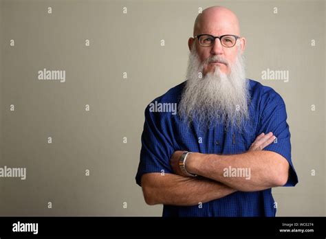 Mature Bearded Bald Man Wearing Eyeglasses With Arms Crossed Stock