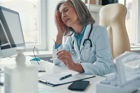 Premium Photo Overworked Mature Female Doctor In White Lab Coat
