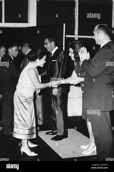 Full Length Shot Of Formally Dressed Men And Women Greeting Each In A