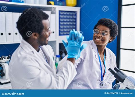 African American Man And Woman Scientists High Five With Hands Raised