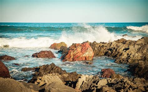 Red Rock Beach New Zealand Coastal Line With Rocks And Sea View Stock