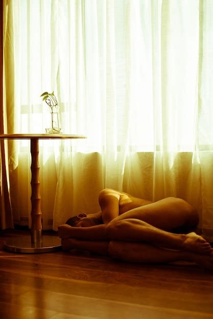 Premium Photo Naked Woman Lying On Hardwood Floor At Home