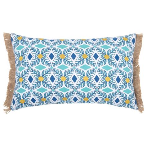 A Blue And Yellow Pillow With Fringes On The Bottom In Front Of A