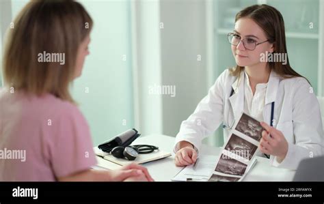 Gynecologist Doctor Communicates With Patient And Examines Results Of