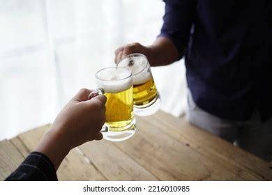 Two Friends Toasting Glasses Light Beer Stock Photo 2216010985