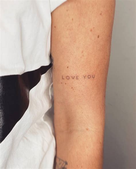 Love You Lettering Tattoo Located On The Upper Arm