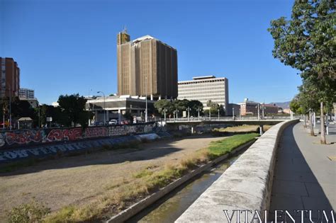 Imposing Brutalist Architecture Concrete Bridge Over Murky River